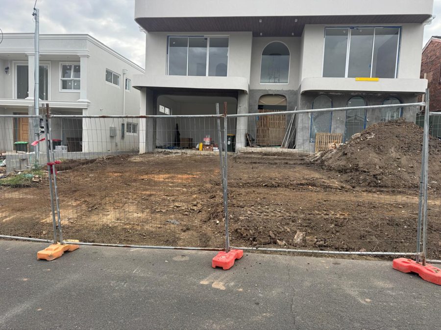 Bare front yard before a new concrete driveway